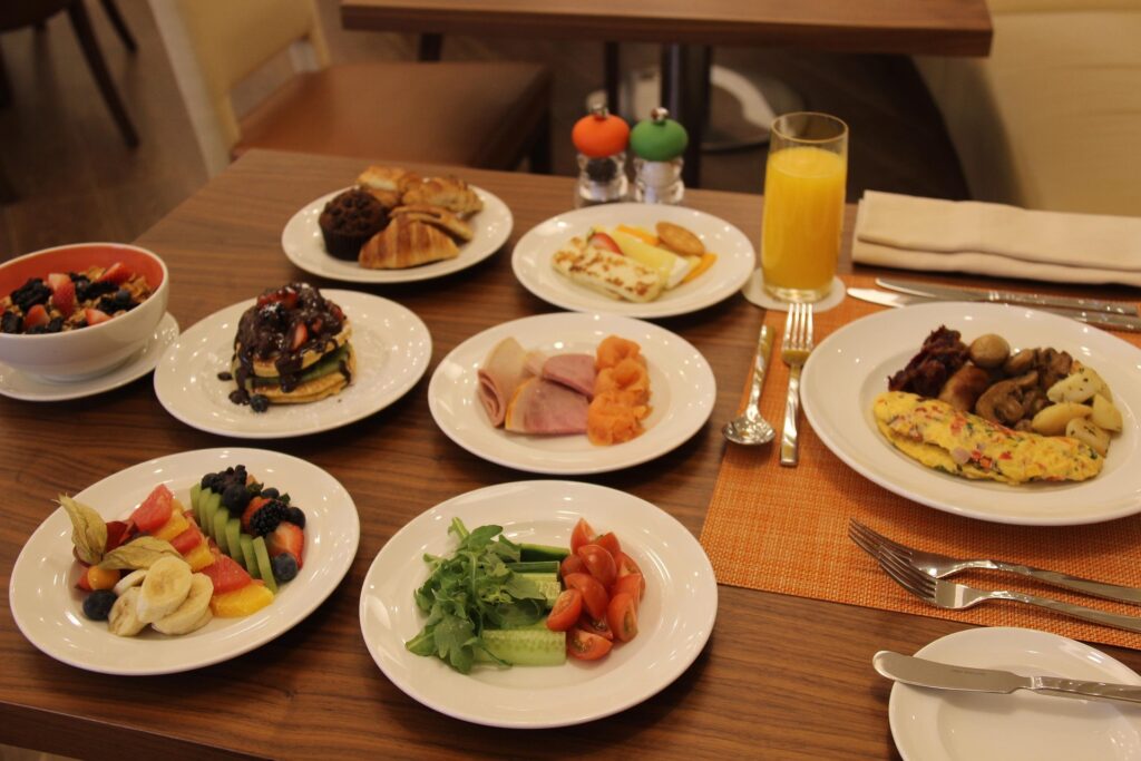 Hotel breakfast buffet with fresh fruit, pastries, and coffee – a hidden perk in many hotel bookings