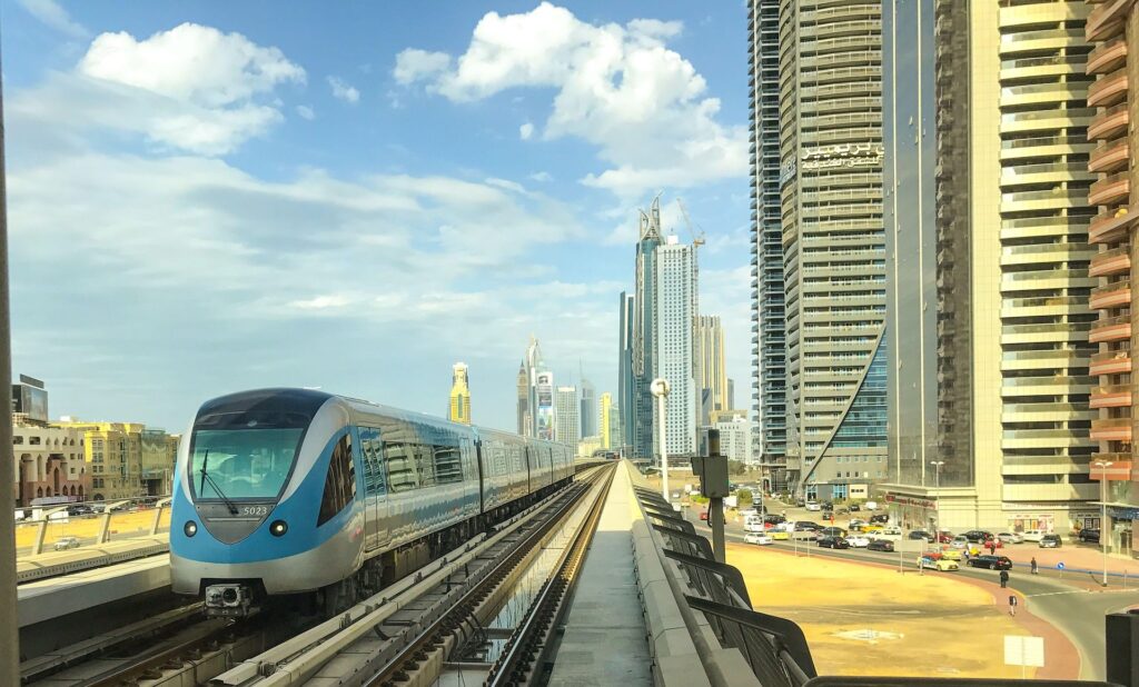 Dubai Metro train, Careem car, and public bus with smartphone app interfaces, representing diverse UAE transportation options
