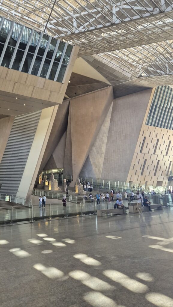 Grand Egyptian Museum building exterior with modern geometric architecture near the Giza Pyramids, Cairo, Egypt